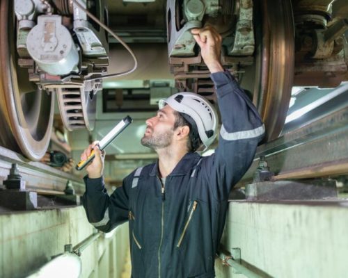 Railway technicians inspect the suspension brakes and axle stability control systems of electric